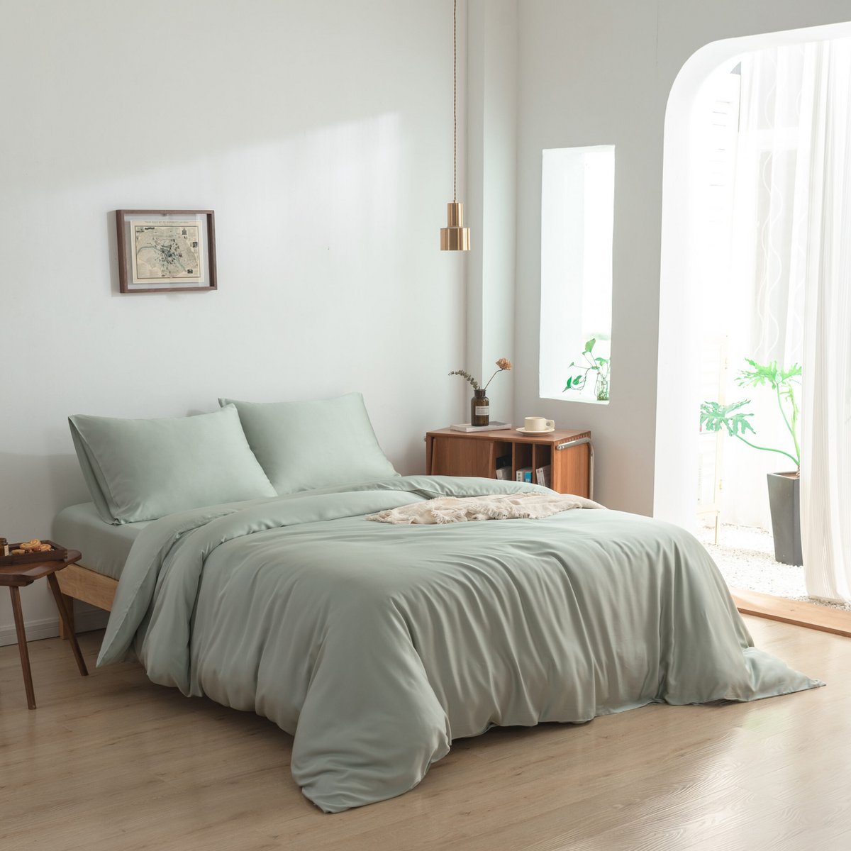 Sage Green bamboo bedding set on a fully made bed