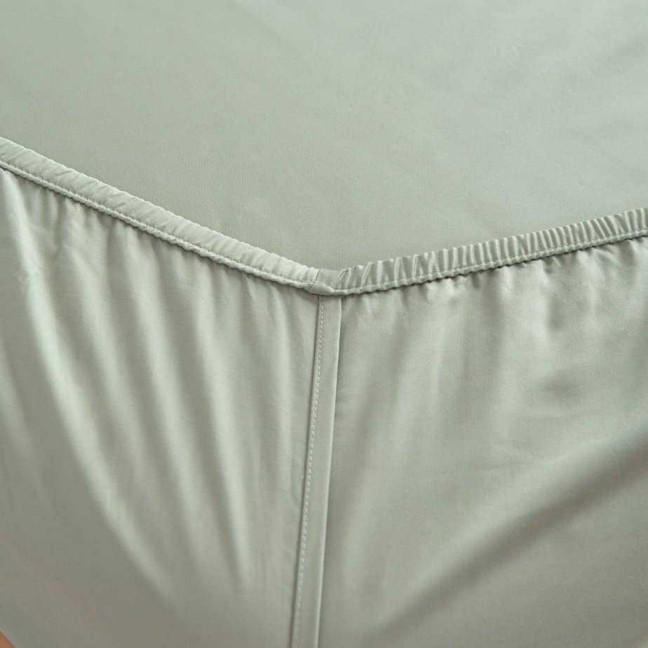 Sage Green bamboo fitted sheet showing its elasticated corner