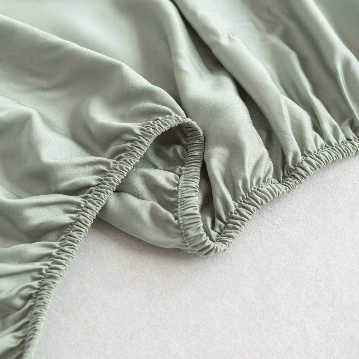 Sage Green bamboo fitted sheet showing its soft, gathered elastic edge