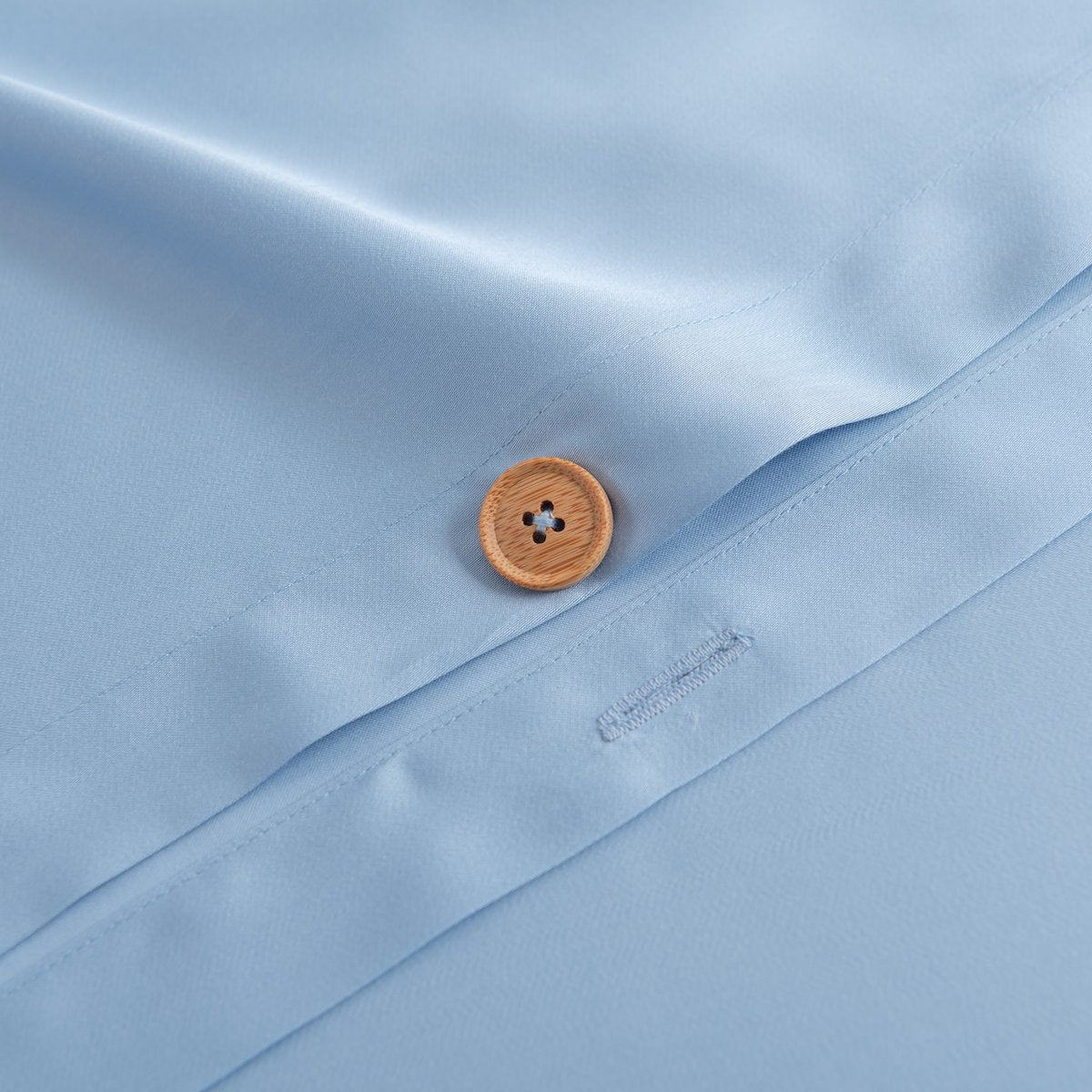 Close-up of the button/tag detail on the Sky Blue bamboo bedding