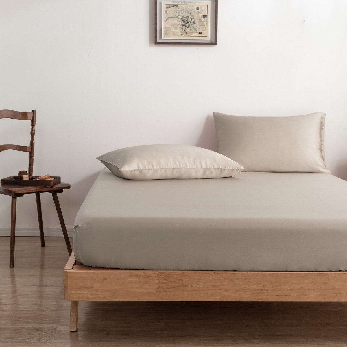 Soft Taupe bamboo bedding set styled on a bed with a chair