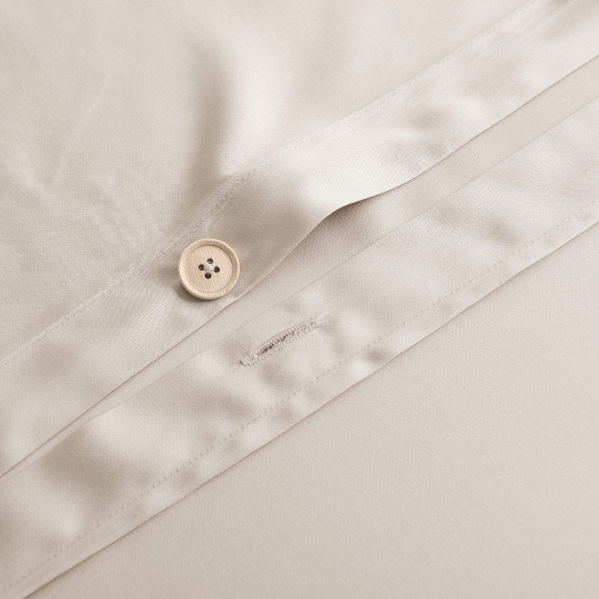 Close-up of the button/tag detail on the Soft Taupe bamboo bedding