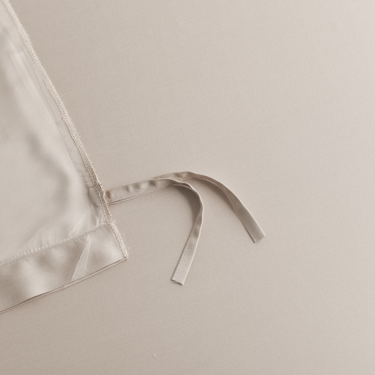 Close-up of a tie/closure detail on the Soft Taupe bamboo bedding