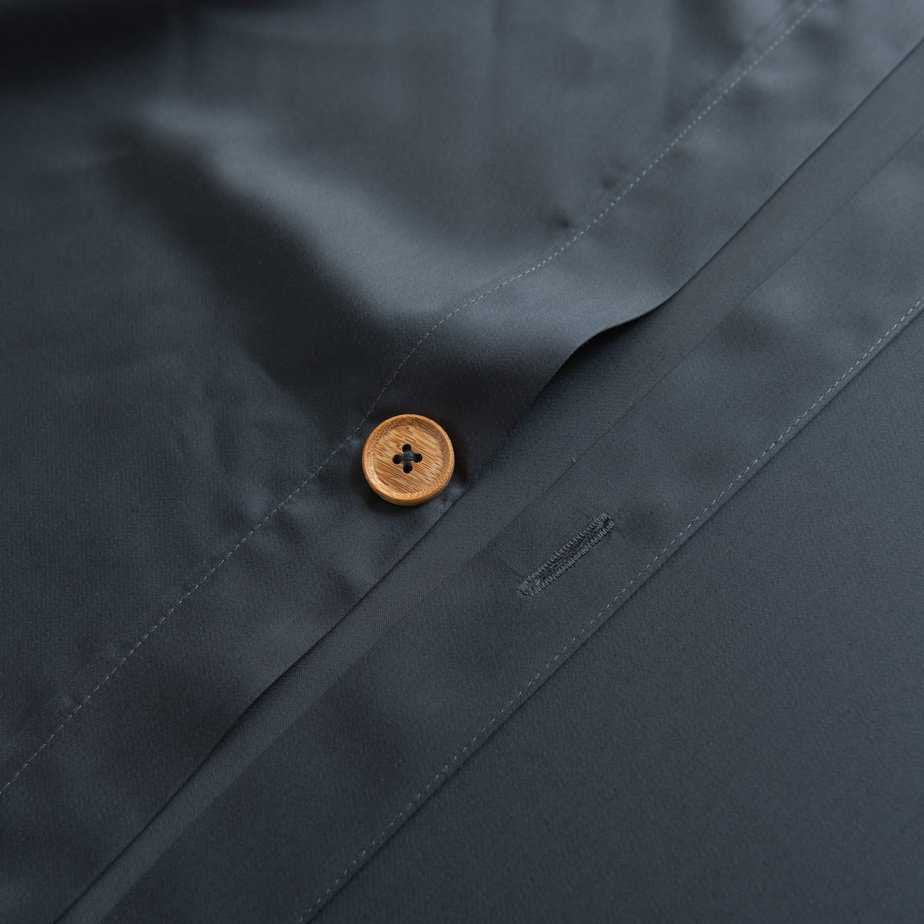 Close-up of the button/tag detail on the Space Blue bamboo bedding