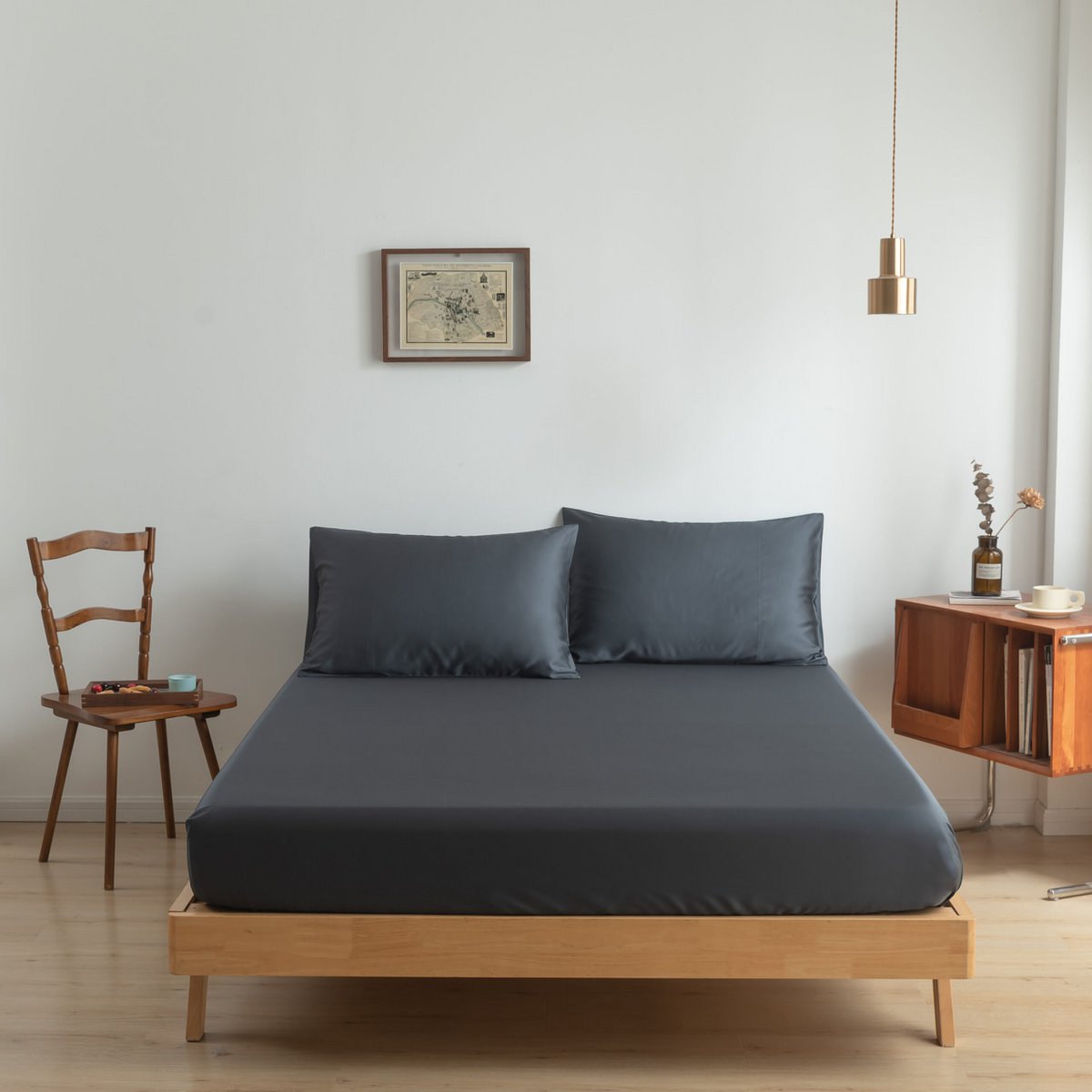 Space Blue bamboo bedding set styled on a bed with chairs