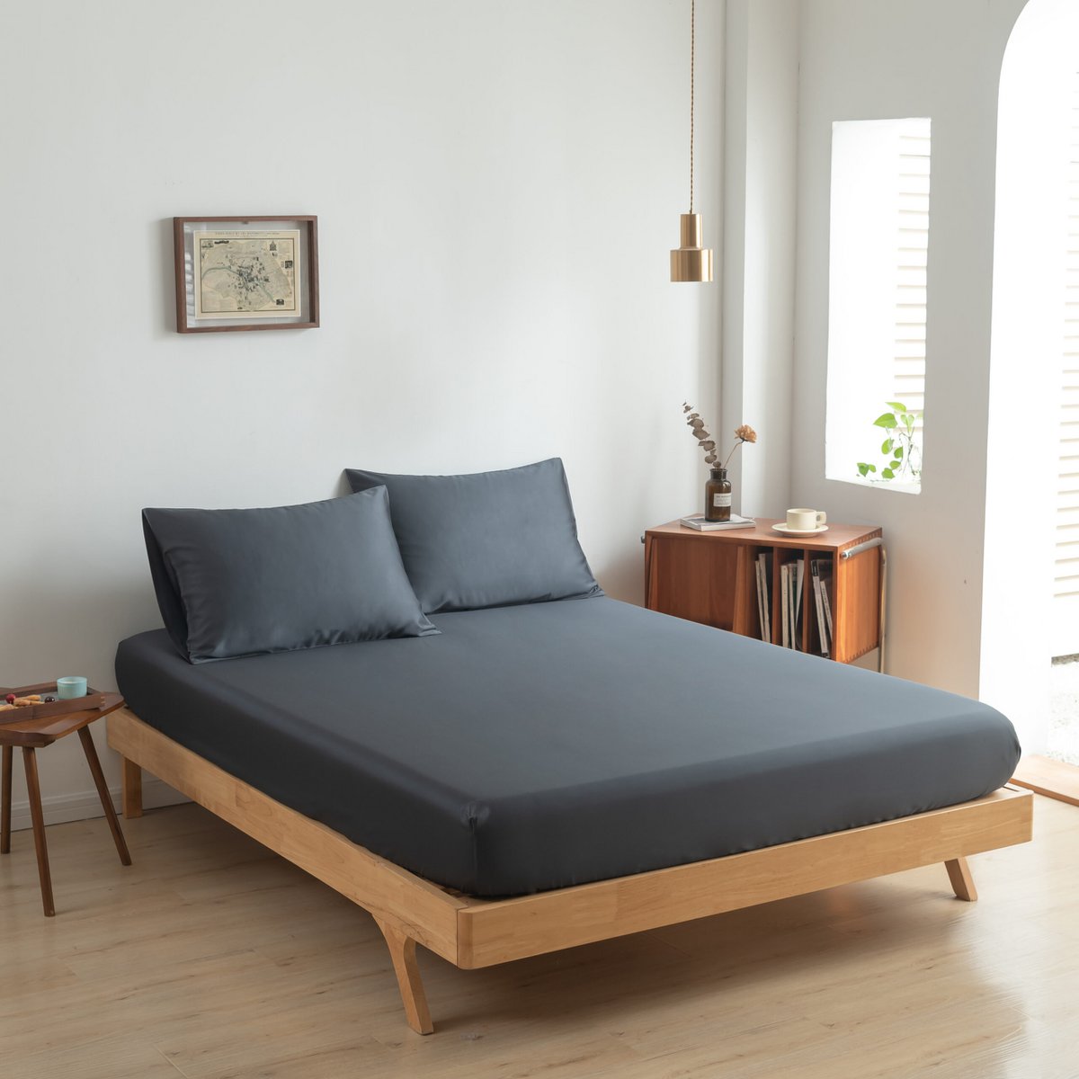 Space Blue bamboo bedding set on a wood-framed bed
