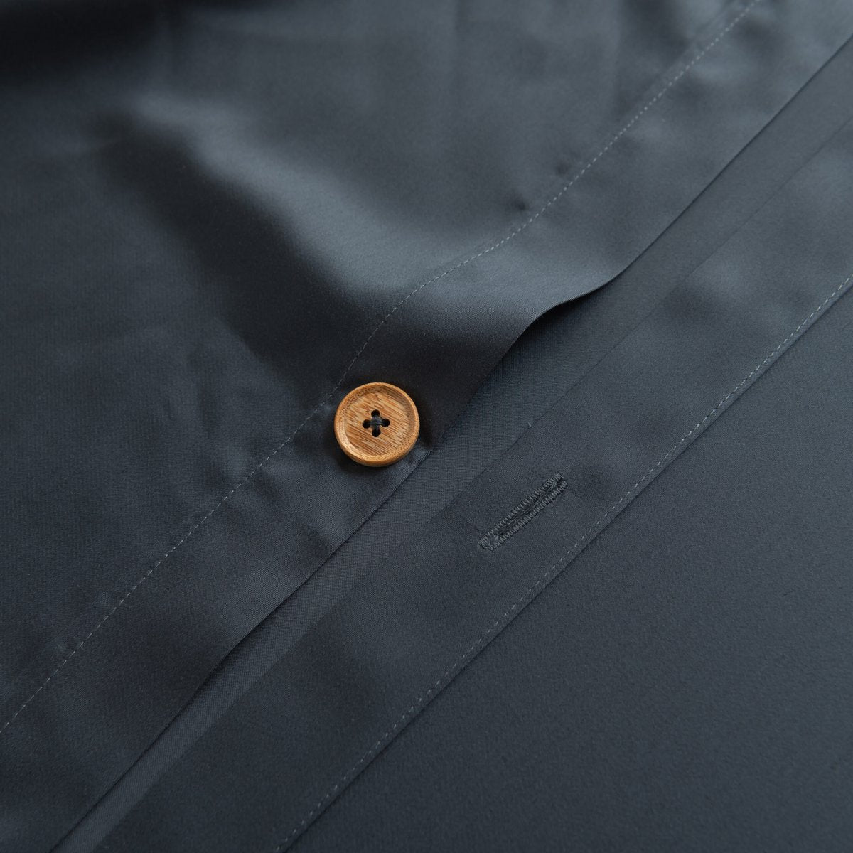Close-up of the button/tag detail on the Space Blue bamboo bedding