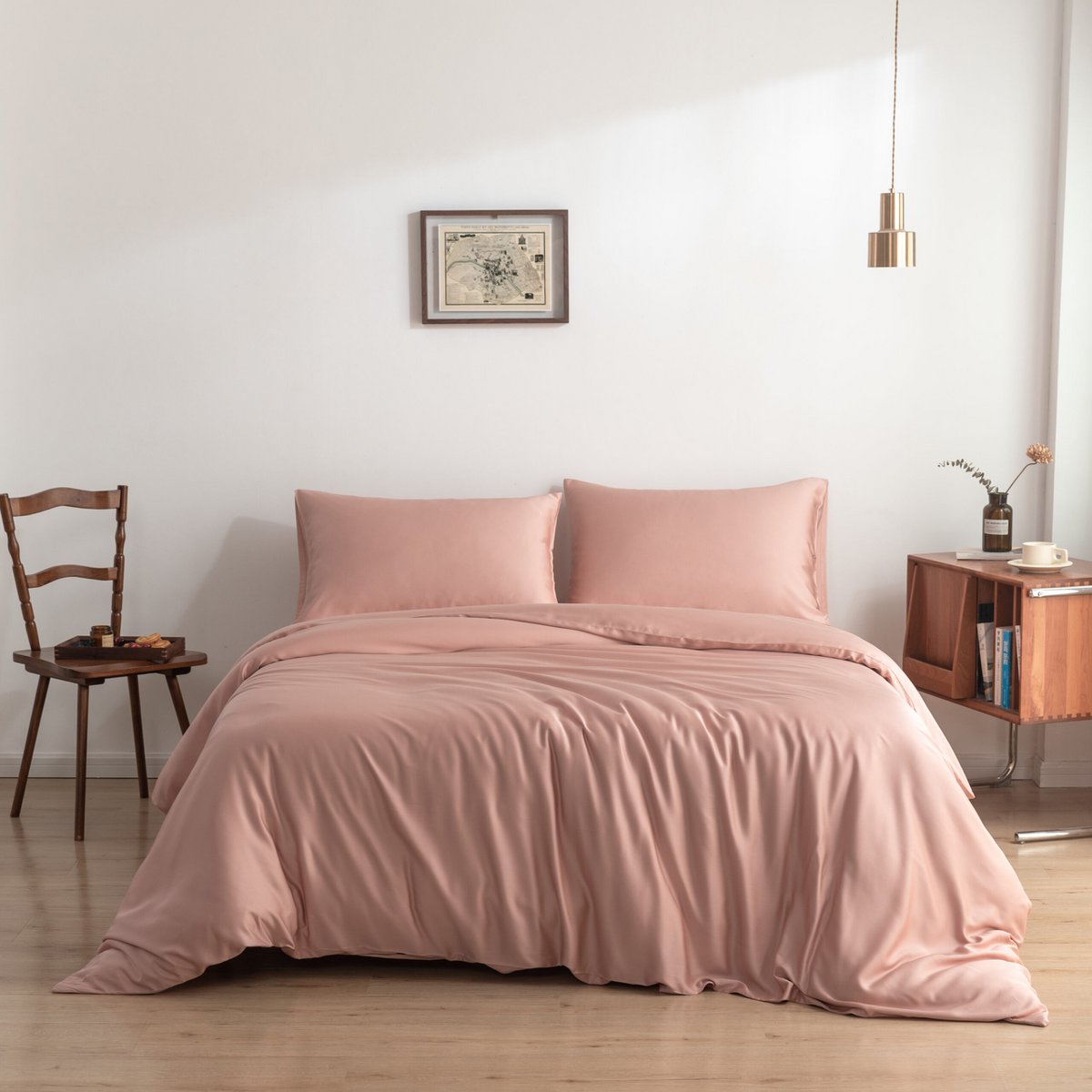 Bamboo duvet cover in Cuddle Pink on a bed beside a wooden chair and cream nightstand