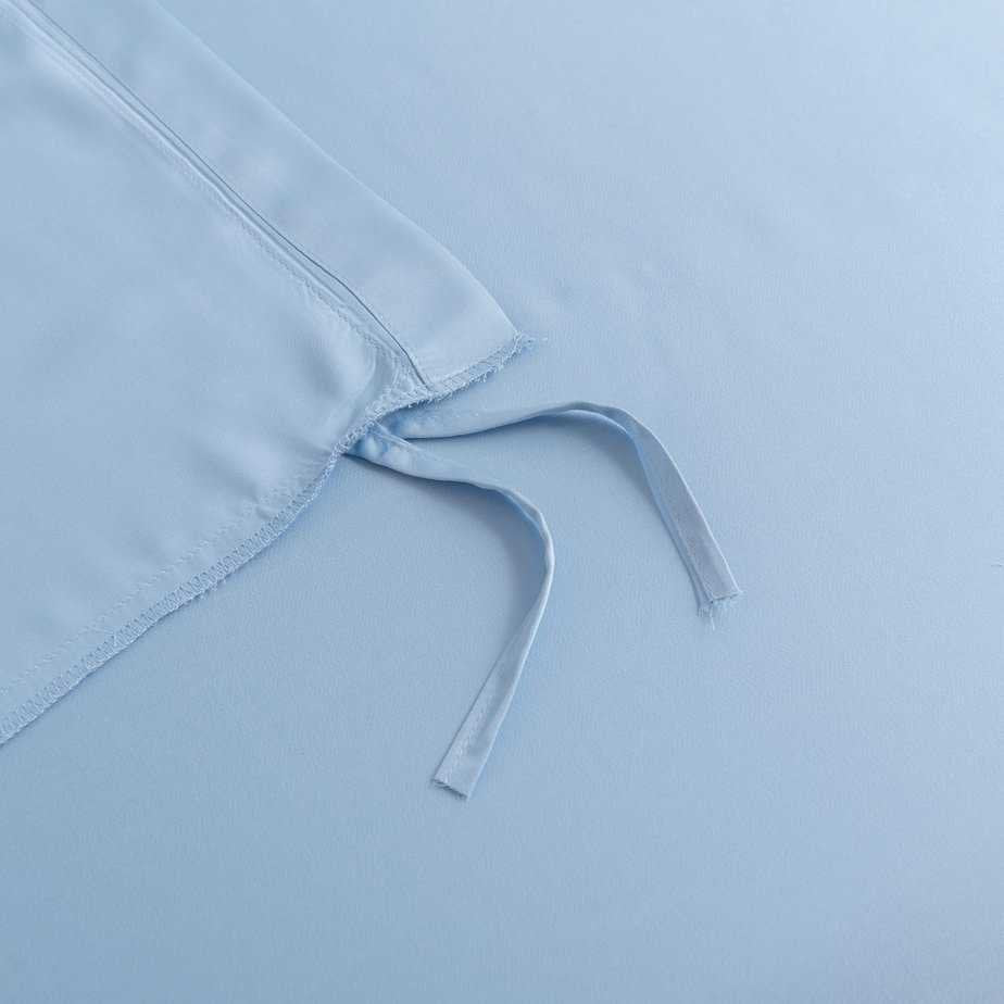 Close-up of the tuck-in strip ties on the corner of the Sky Blue bamboo duvet cover