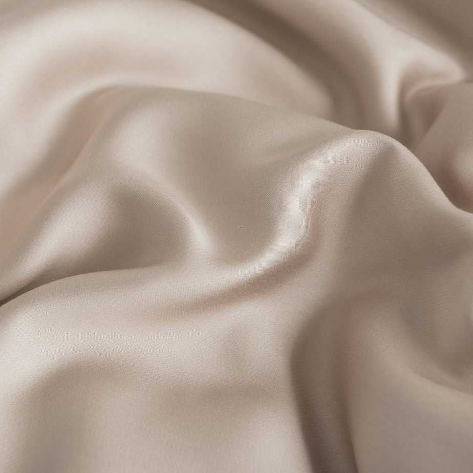 Close-up of the silky, folded 400TC bamboo fabric in Soft Taupe showing its smooth sheen