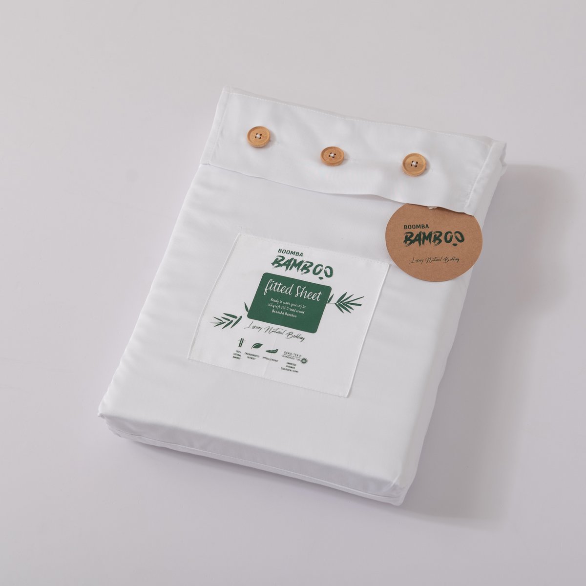 Coco White bamboo fitted sheet folded and packaged with the Boomba Bamboo product label.