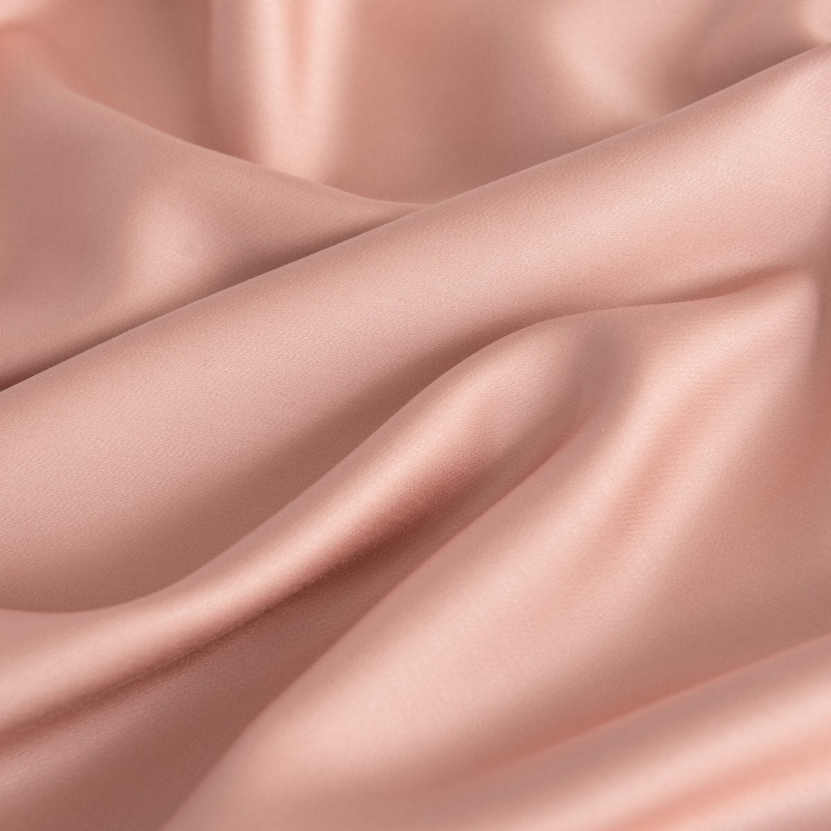 Close-up of draped Cuddle Pink bamboo fabric highlighting its soft sheen.