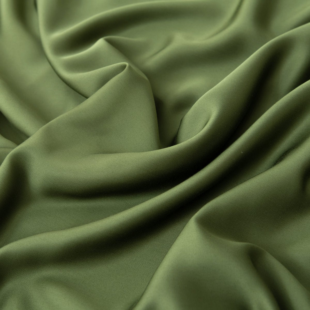 Close-up of swirled Deep Moss bamboo fabric highlighting its soft sheen.