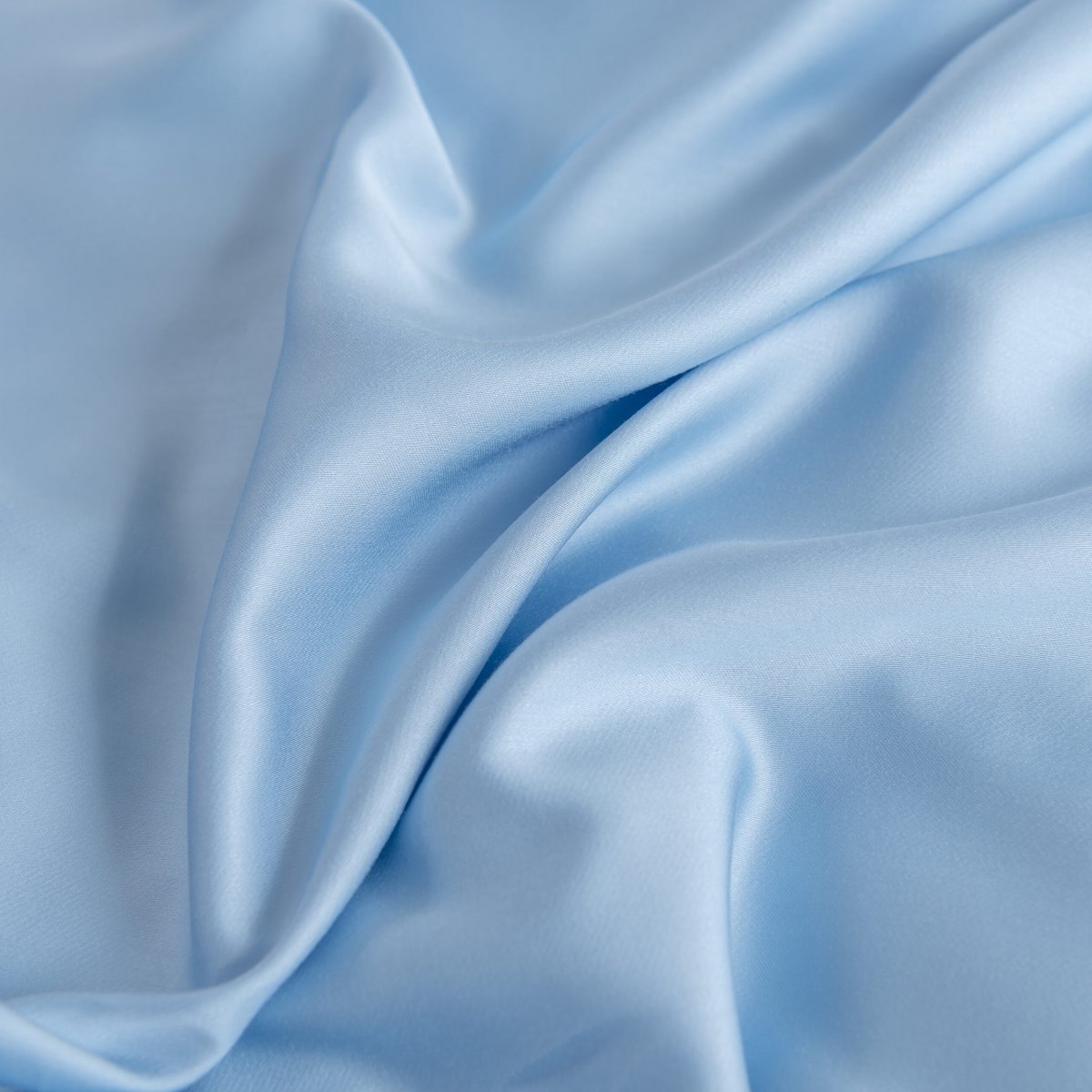 Draped Sky Blue bamboo fitted sheet fabric showing its soft, silky finish