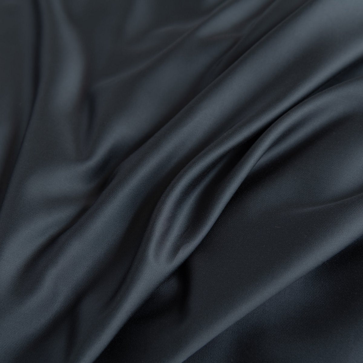 Close-up of folded Space Blue bamboo fabric showing its smooth texture.