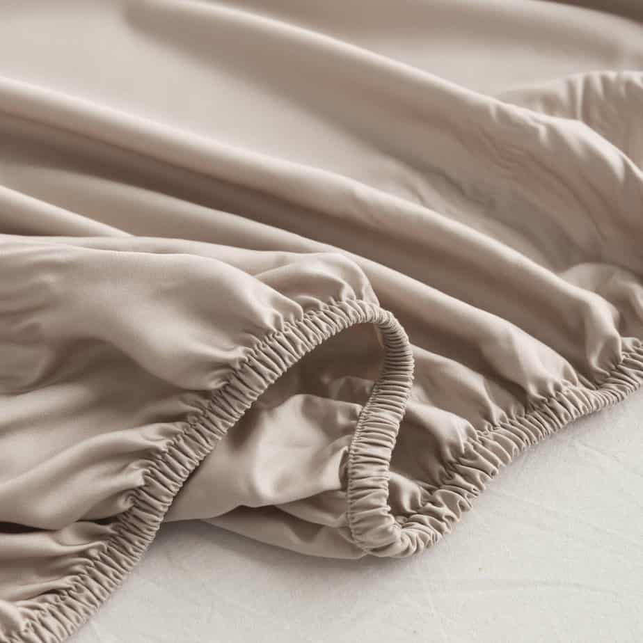 Close-up of the Soft Taupe bamboo fitted sheet's folded elastic corner.