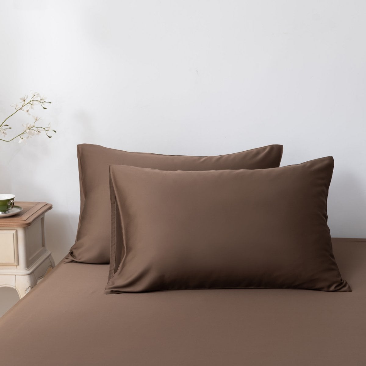 Coffee Brown bamboo pillowcases styled on a made bed