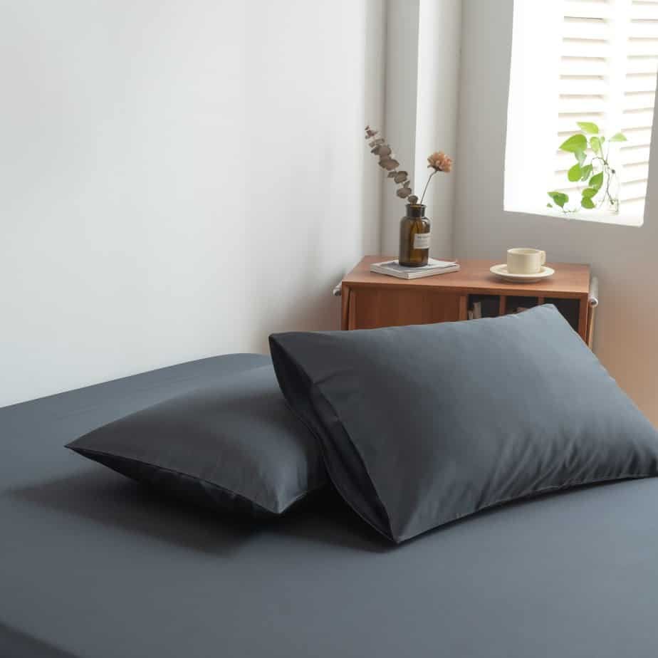 Space Blue bamboo pillowcases styled on a chair