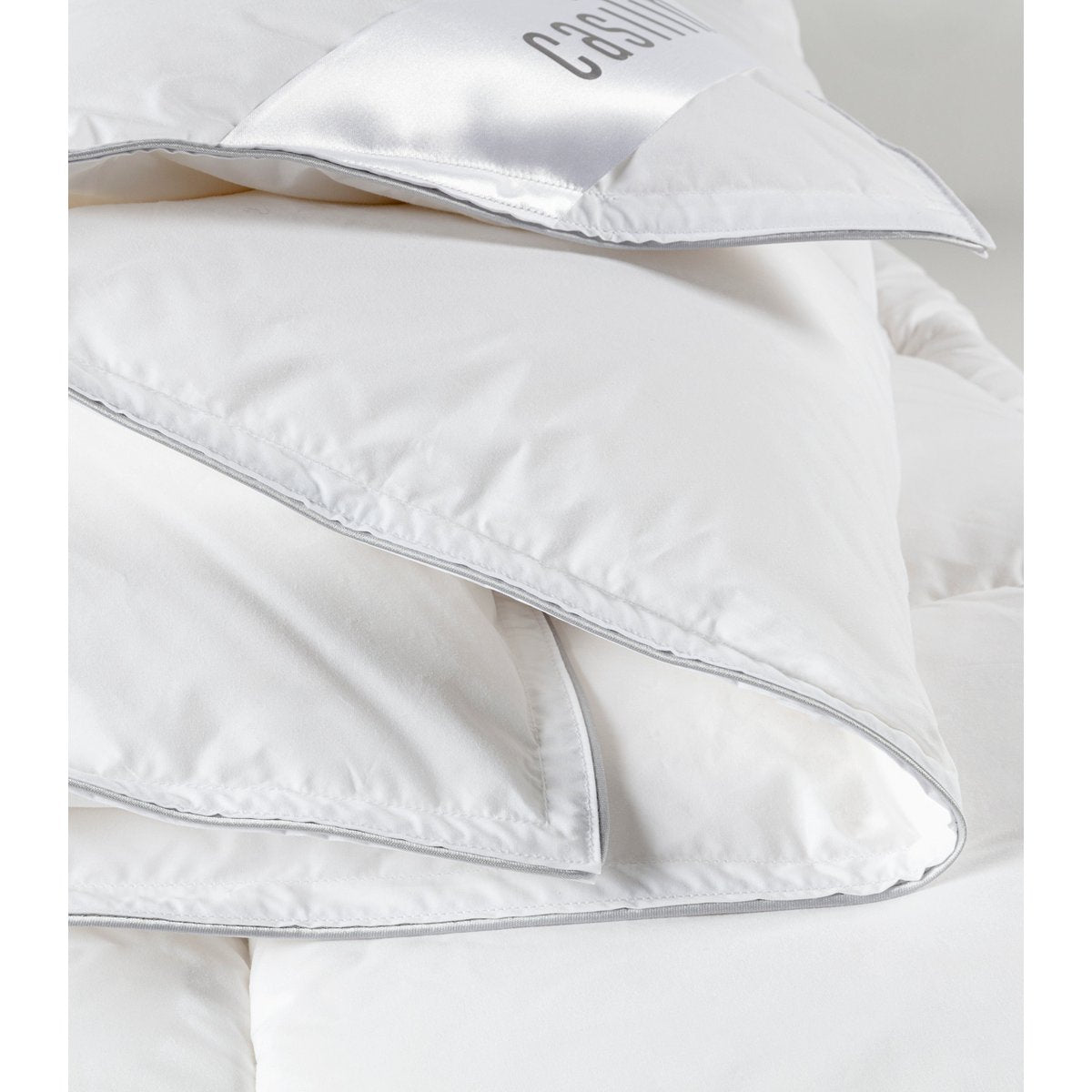Close-up of the folded Casilin Duvet Crown corner showing the branded label