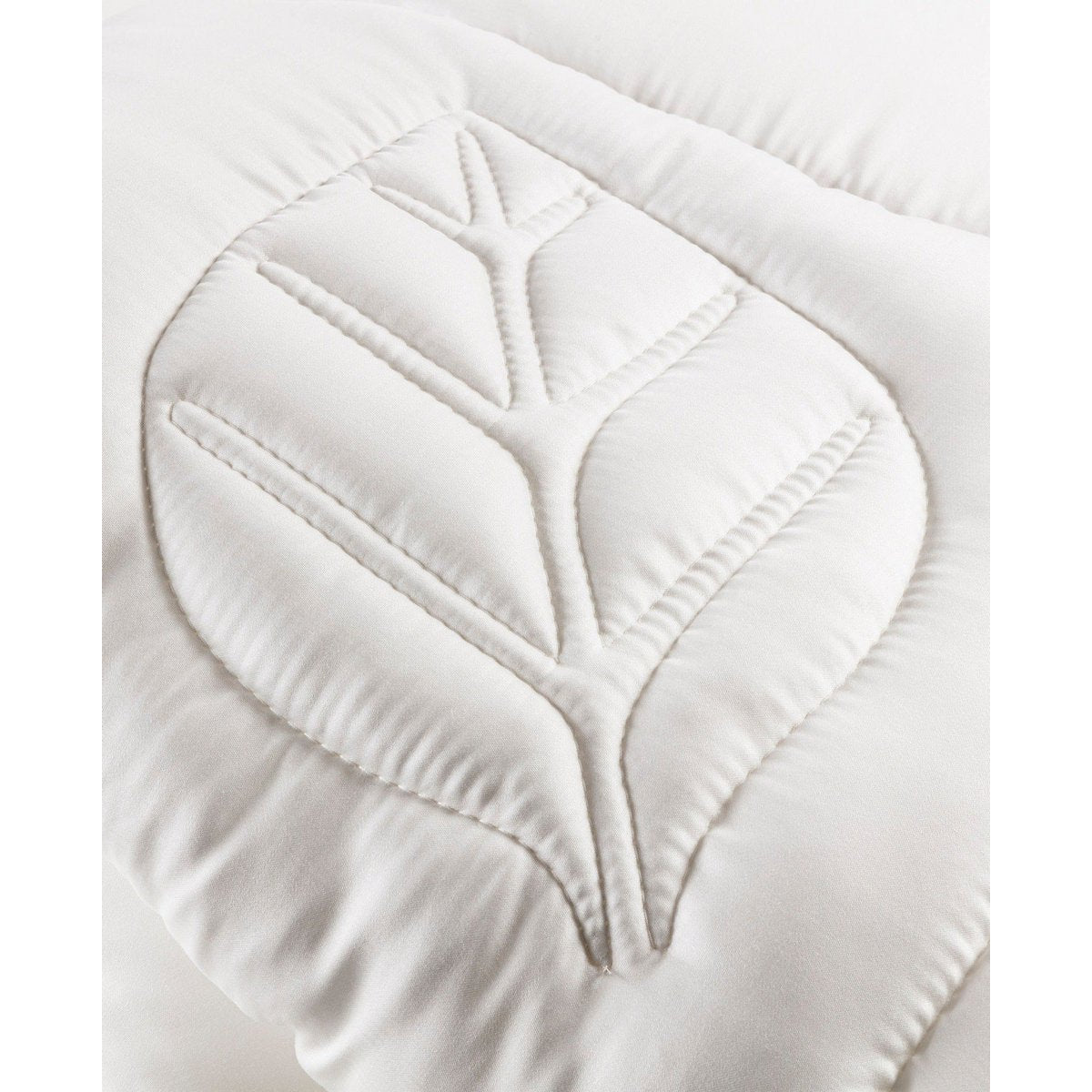 Close-up of the leaf-shaped quilting stitch pattern on the Tencel satin fabric of the Super Soft Mono duvet