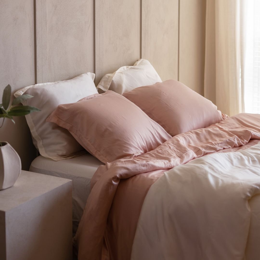 Eco Bamboo Duvet Cover in Powder Peach styled on a bed with a curved headboard
