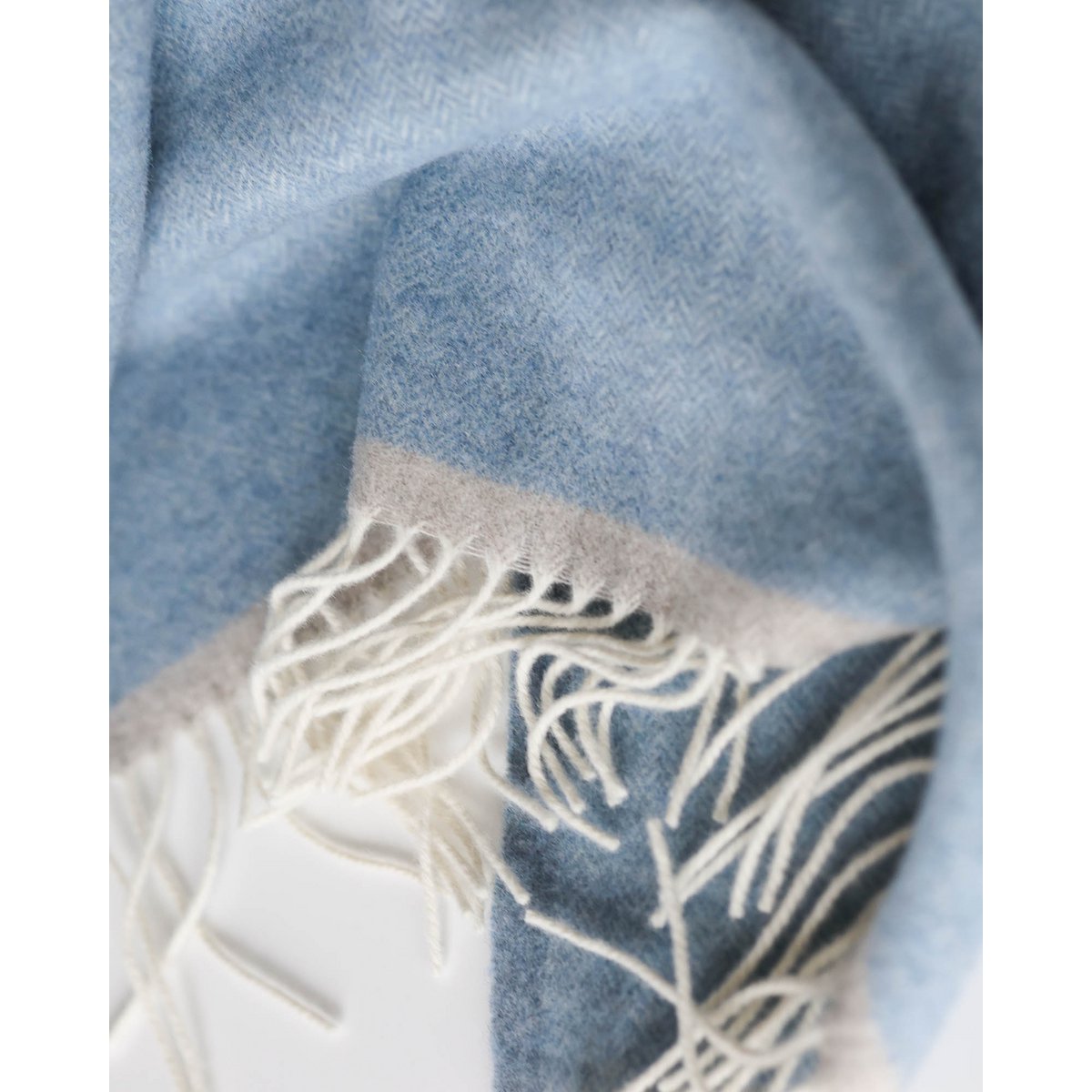 Detail shot of the Milano throw's fringe and weave