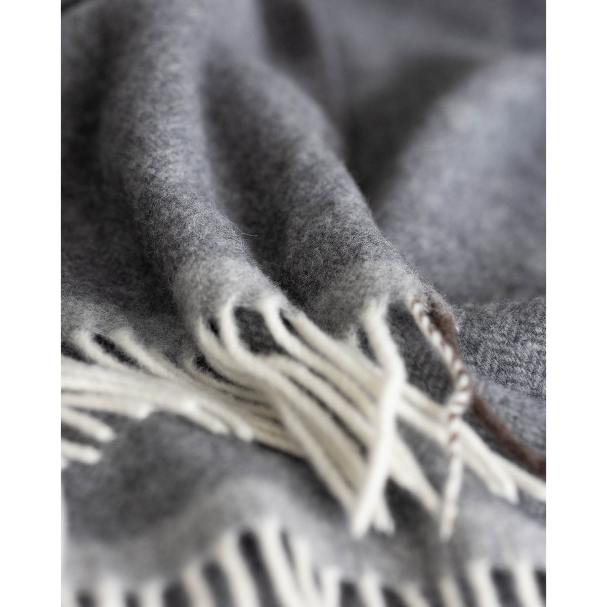 Close-up of Milano Grigio Orlo's subtle tonal edge-trim finish