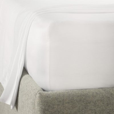 Corner of a white fitted sheet on a grey upholstered bed frame (image shows white, not the beige colorway of this listing)
