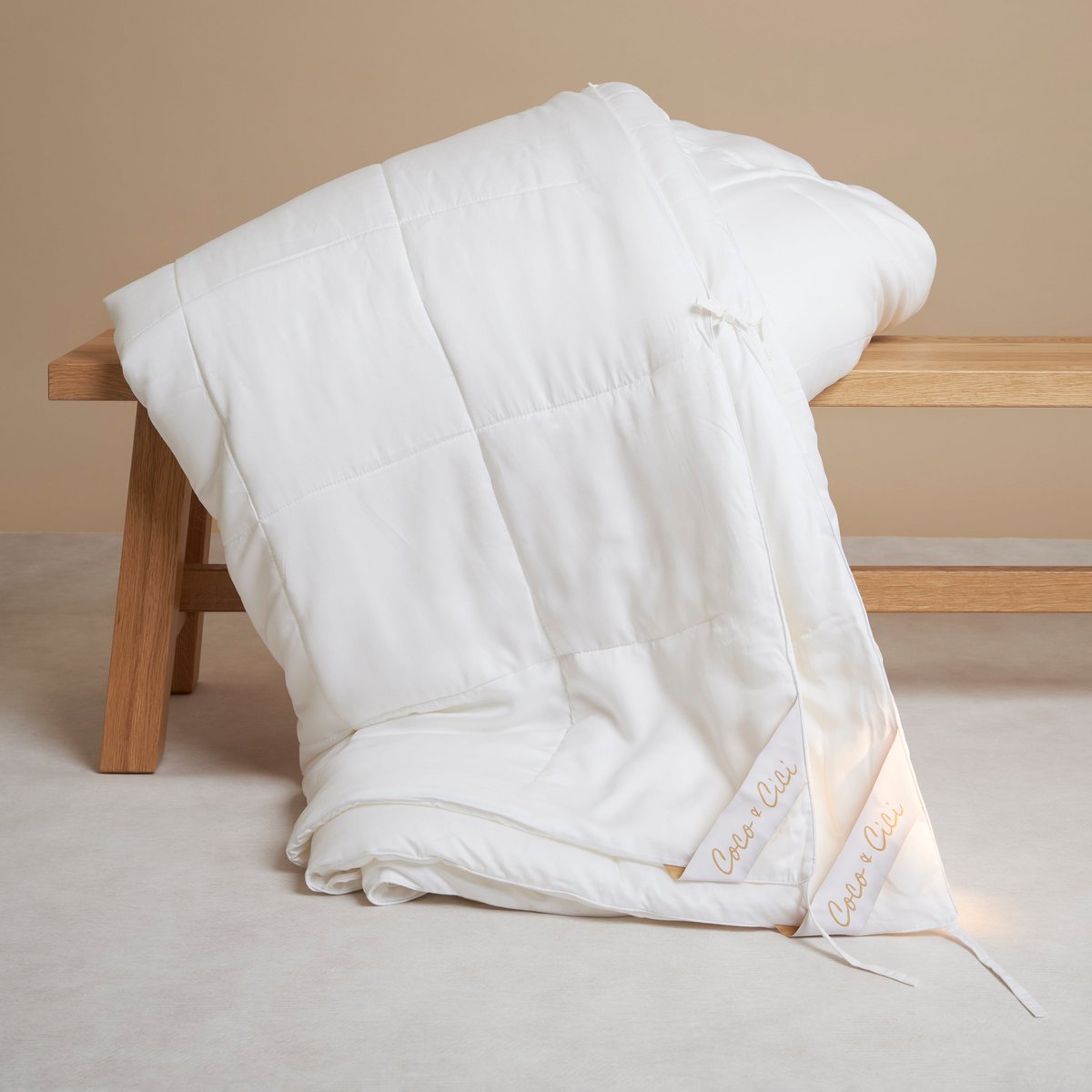 Person shaking out the Tencel™ Four Seasons Duvet