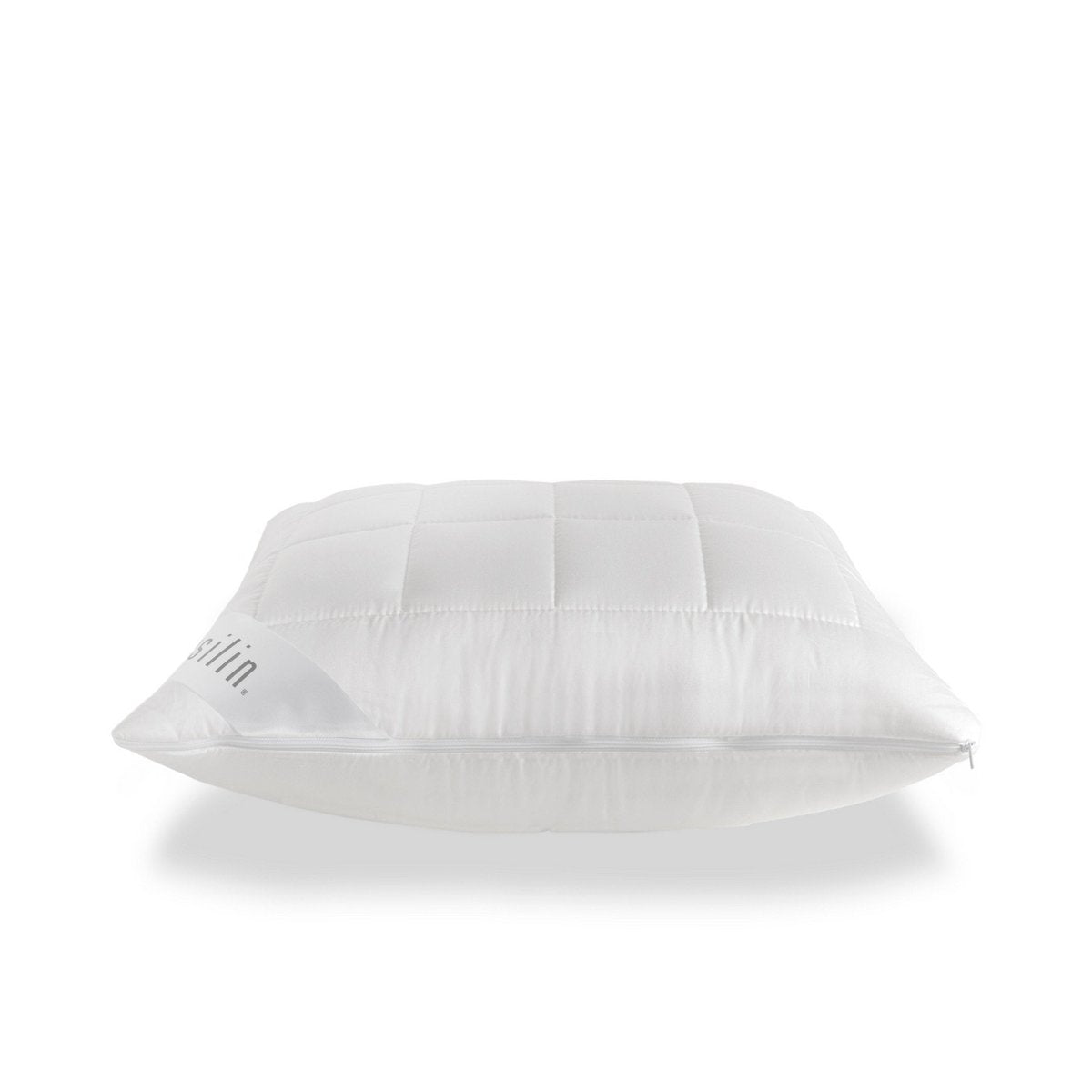 Full product shot of the quilted white Tencel pillow with visible zipper and brand label