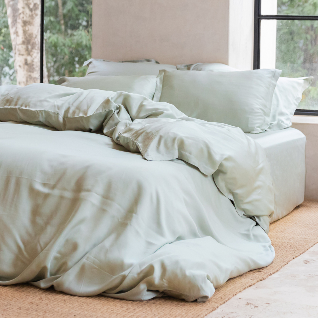 Tencel™ Sateen Duvet Cover in Gray Green styled on a bed, wide view