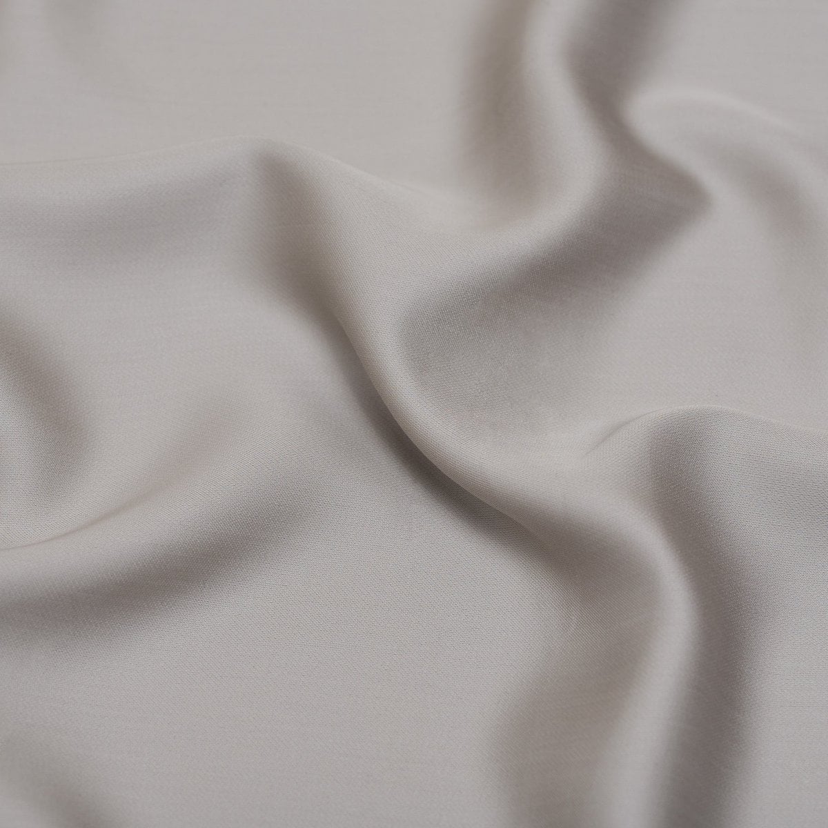Close-up of the Tencel™ Sateen fabric draped, showing texture in Taupe