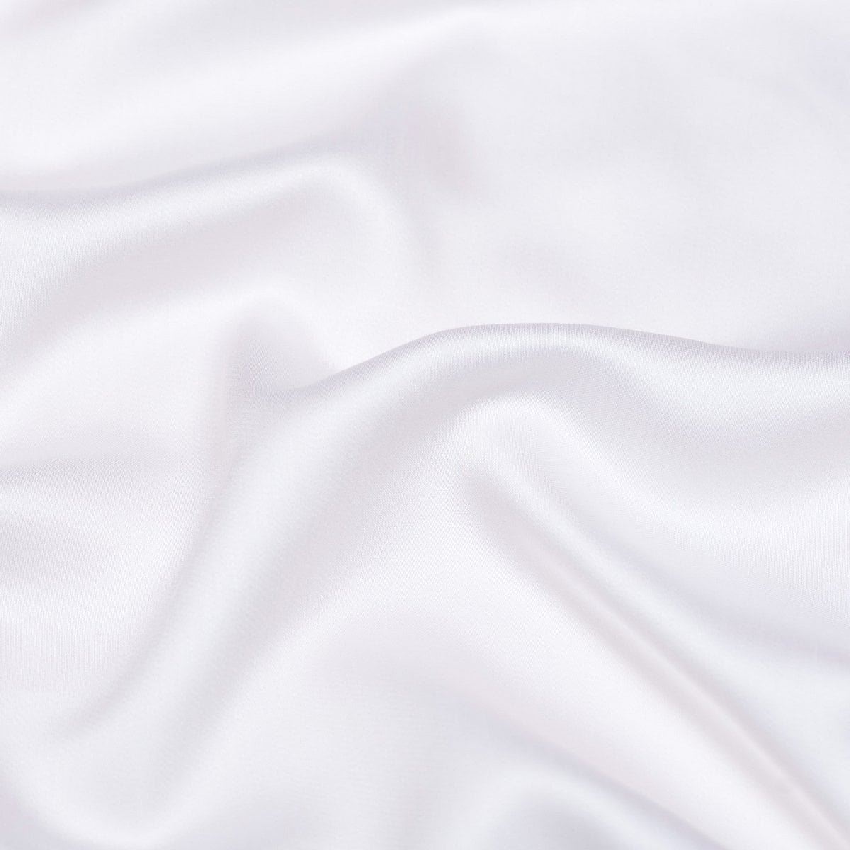 Close-up of the Tencel™ Sateen fabric draped, showing texture in White