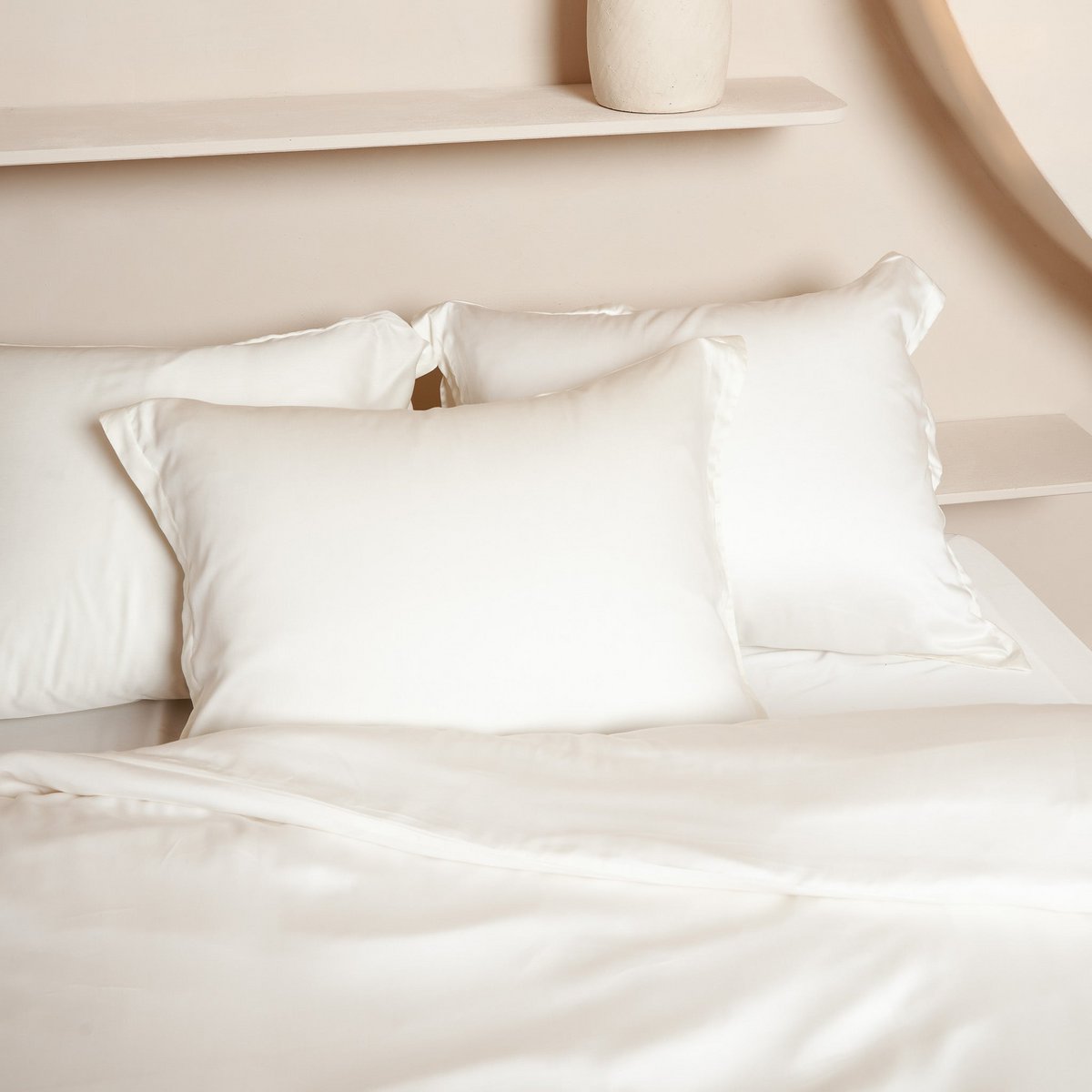 Pair of off white Tencel Sateen pillowcases styled together