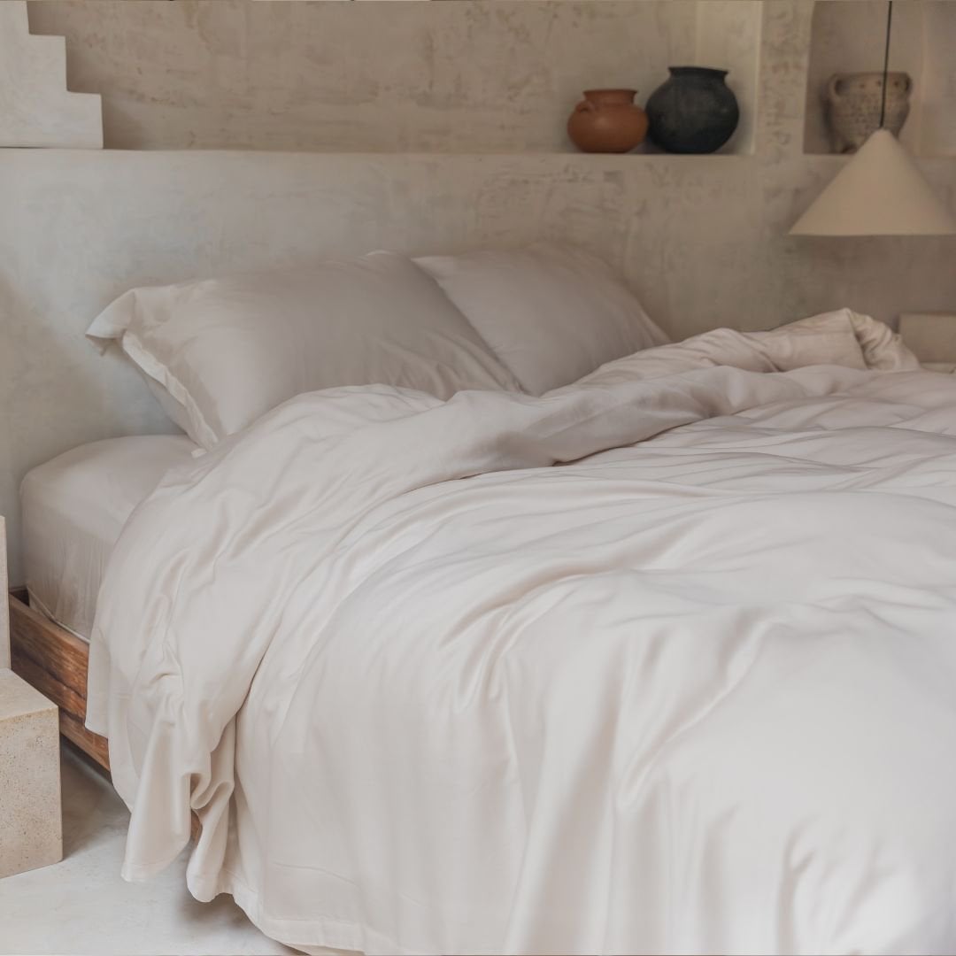 Tencel™ Twill Duvet Cover in Beige styled on a bed with an arched headboard
