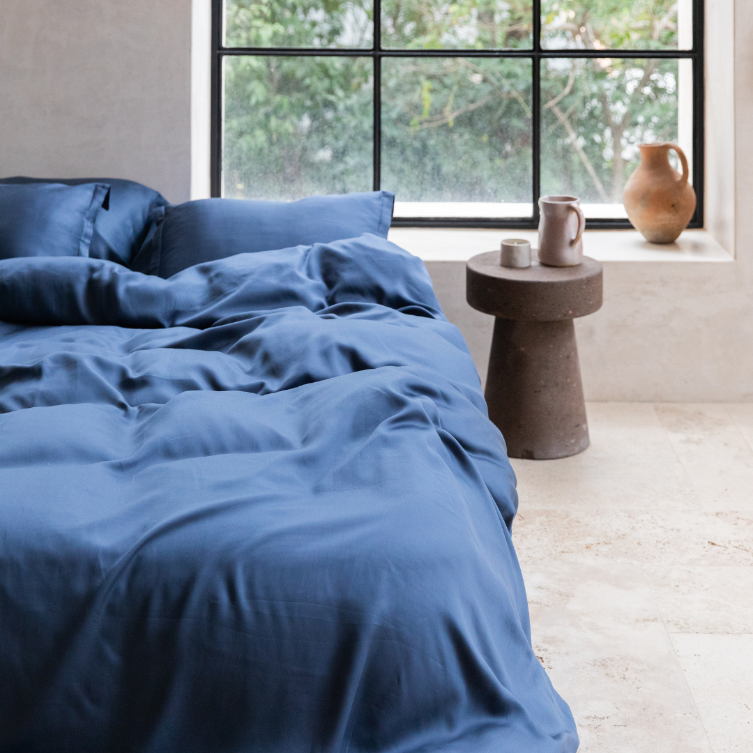 Tencel™ Twill Duvet Cover in Dark Blue styled on a bed, wide view