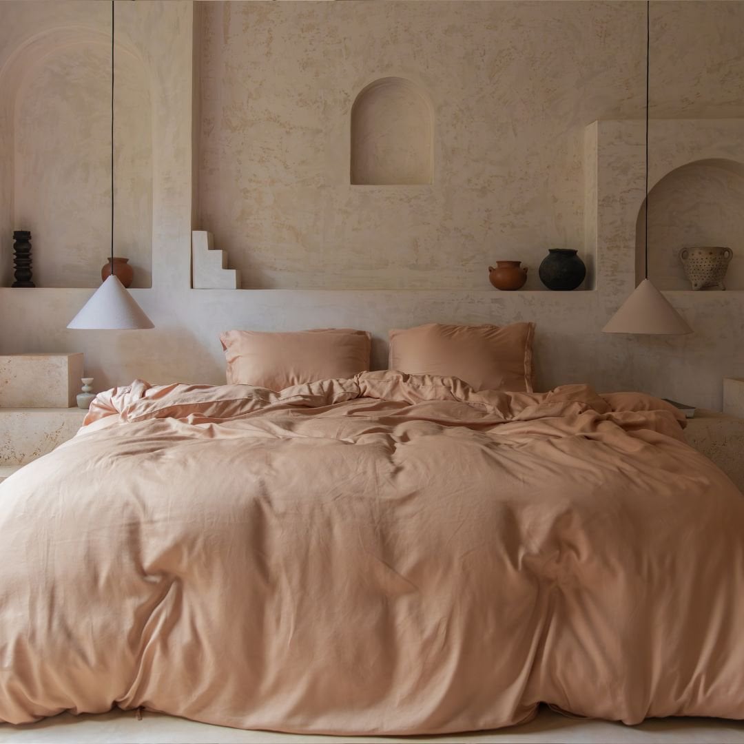 Tencel™ Twill Duvet Cover in Peach styled on a bed with arched alcoves