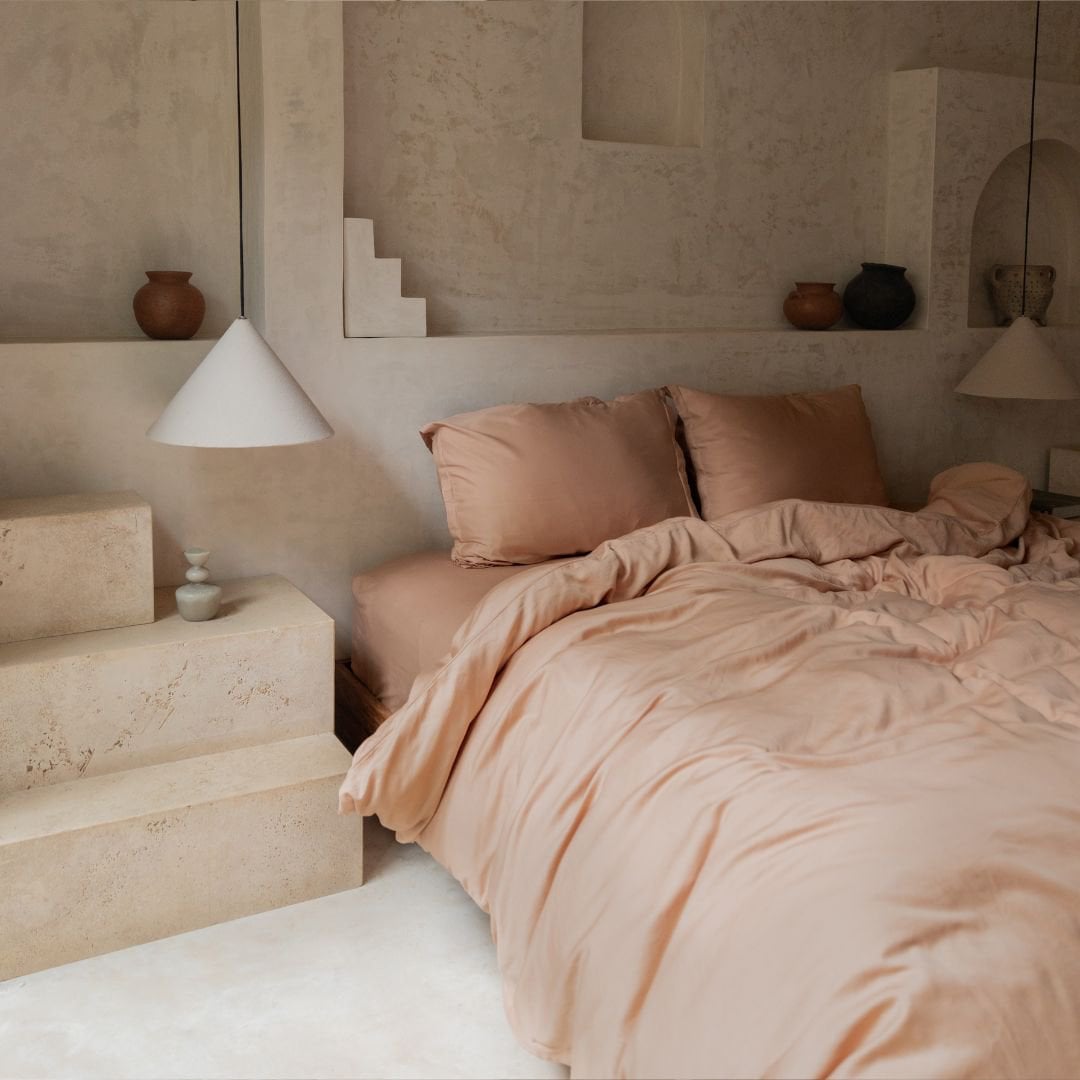 Tencel™ Twill Duvet Cover in Peach styled on a bed, wide view