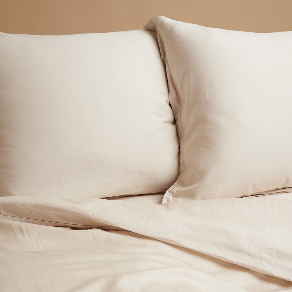 Tencel™ Twill Pillowcases in Beige styled on a bed