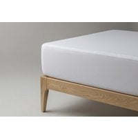 ThermoComfort Frost mattress protector fitted on a wooden bed frame