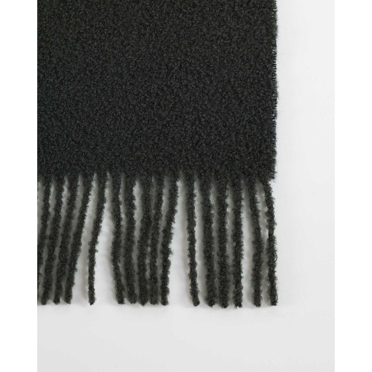 Wool Bouclé Throw Blanket Paris in swamp green styled in a room setting