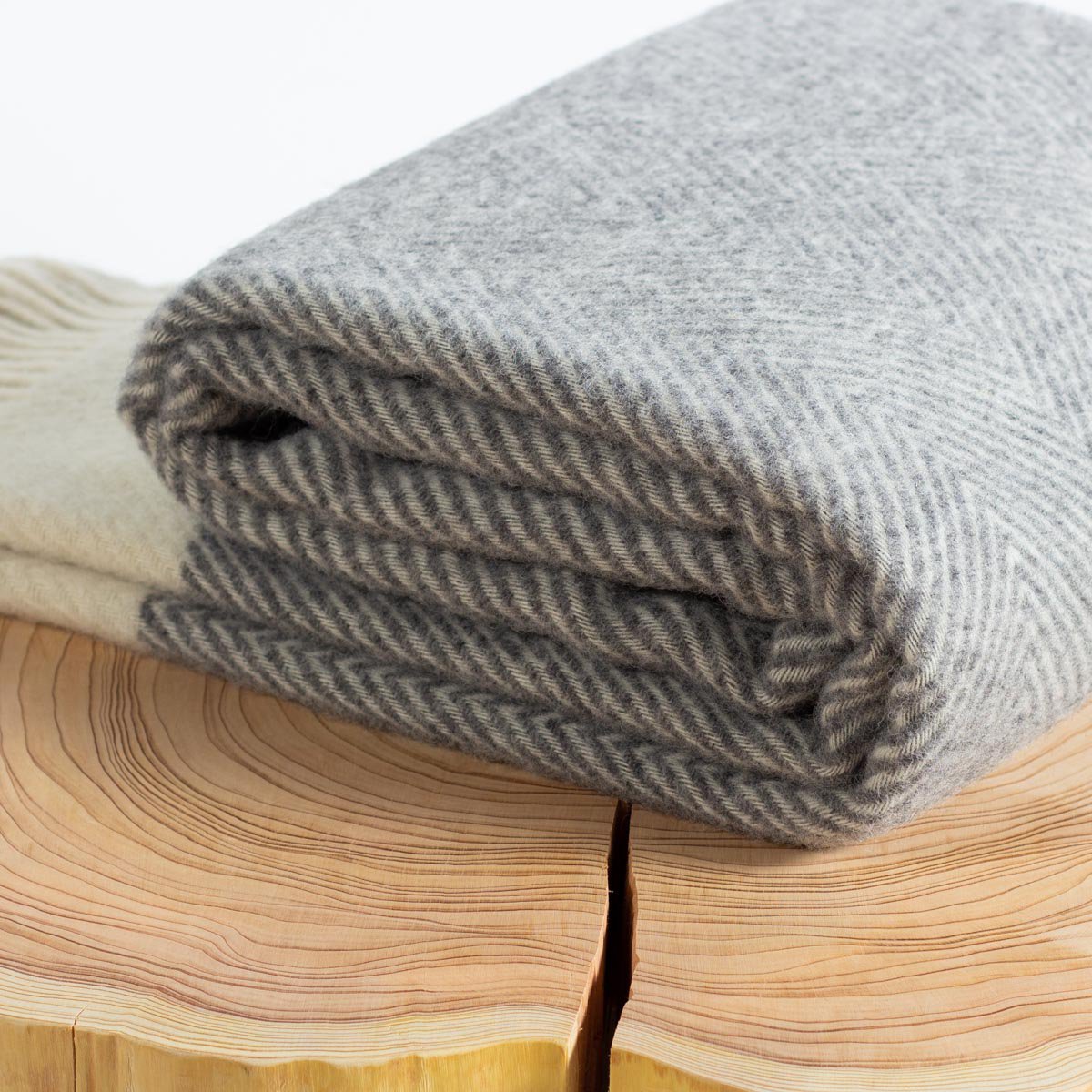 Wool Throw Blanket Florence in grey styled on a surface