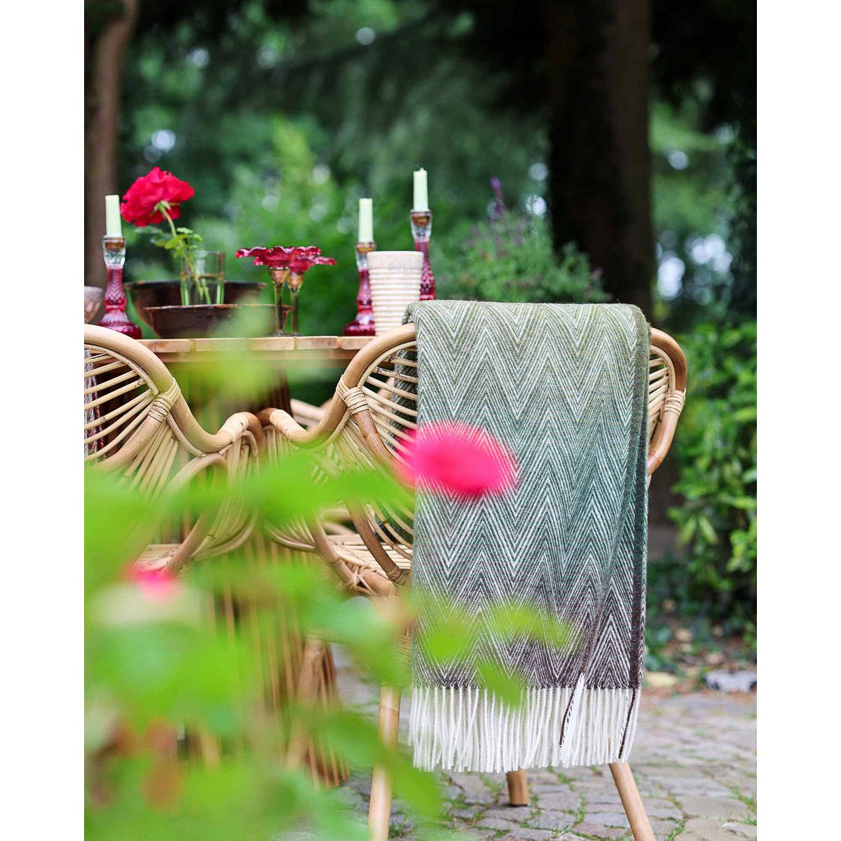 Wool Throw Blanket Manoria Foresta draped in an outdoor setting