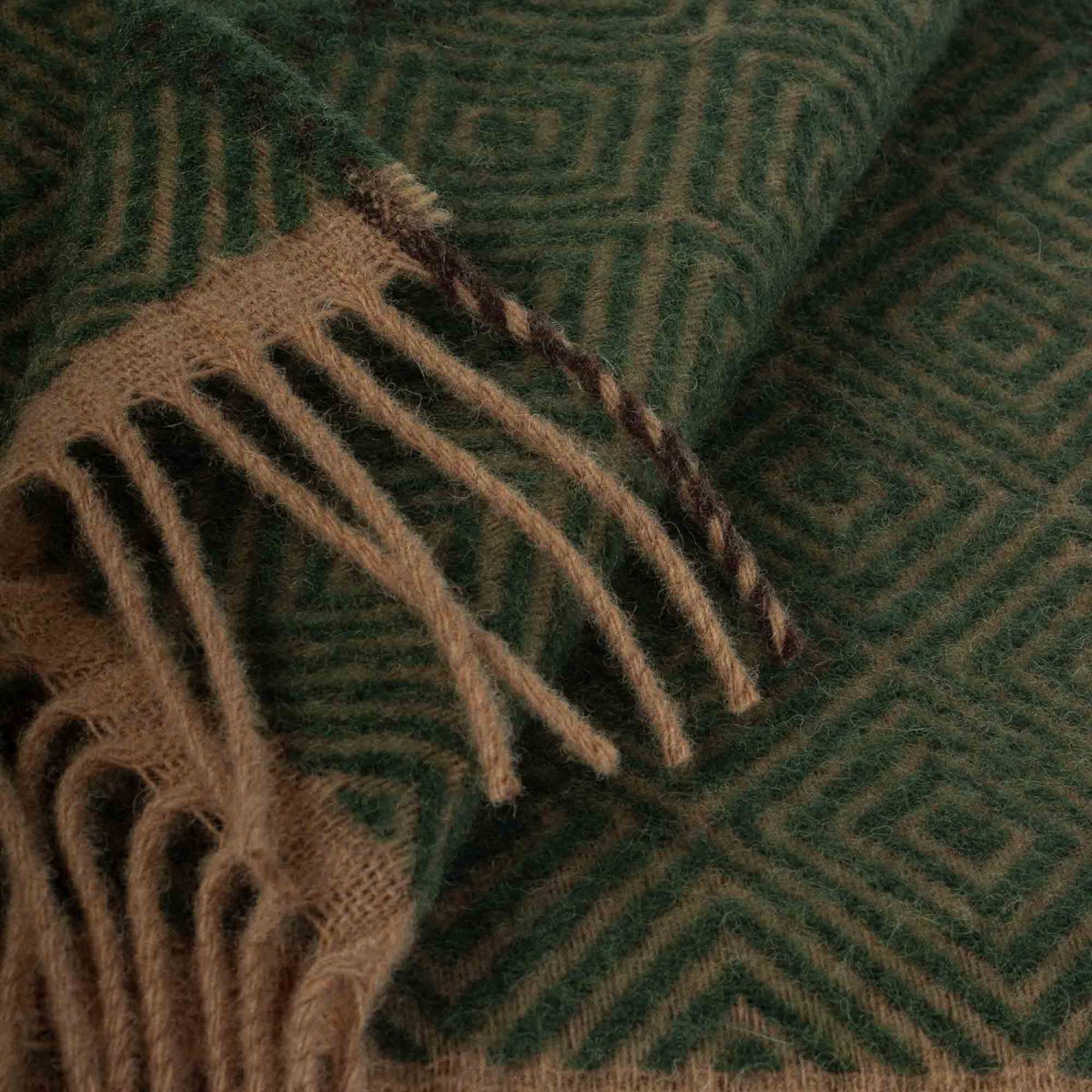 Close-up swatch of Venezia throw's leaf green diamond weave texture